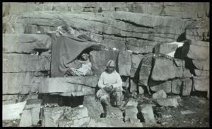 Image of Polar Eskimos [Inughuit] in Rock-Sod Igloo [hunter's bed]